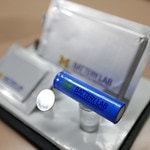 Close up of blue and silver batteries with U-M Battery Lab logos on them. 
